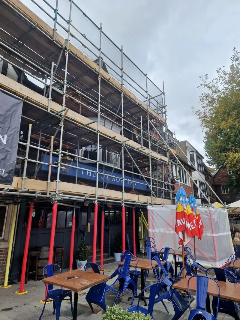 Listed pub frontage — independent scaffold designed around the terrace seating