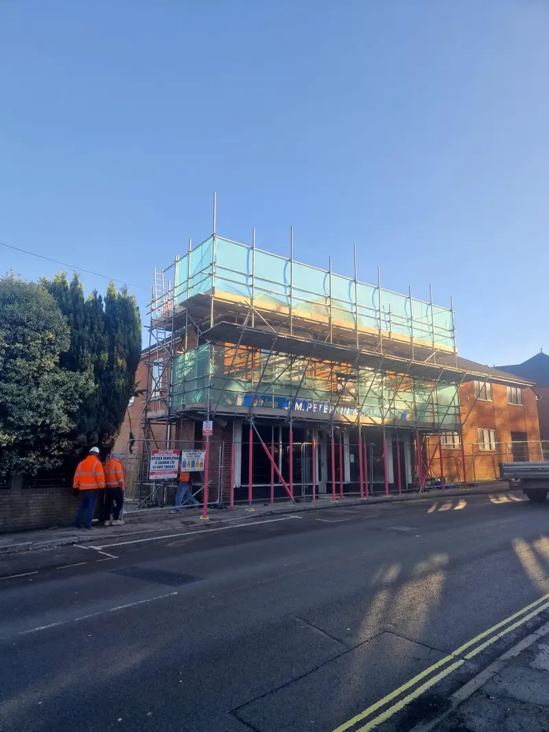 Peterkin & Son shopfront wrap — CISRS-carded operative on site, morning light